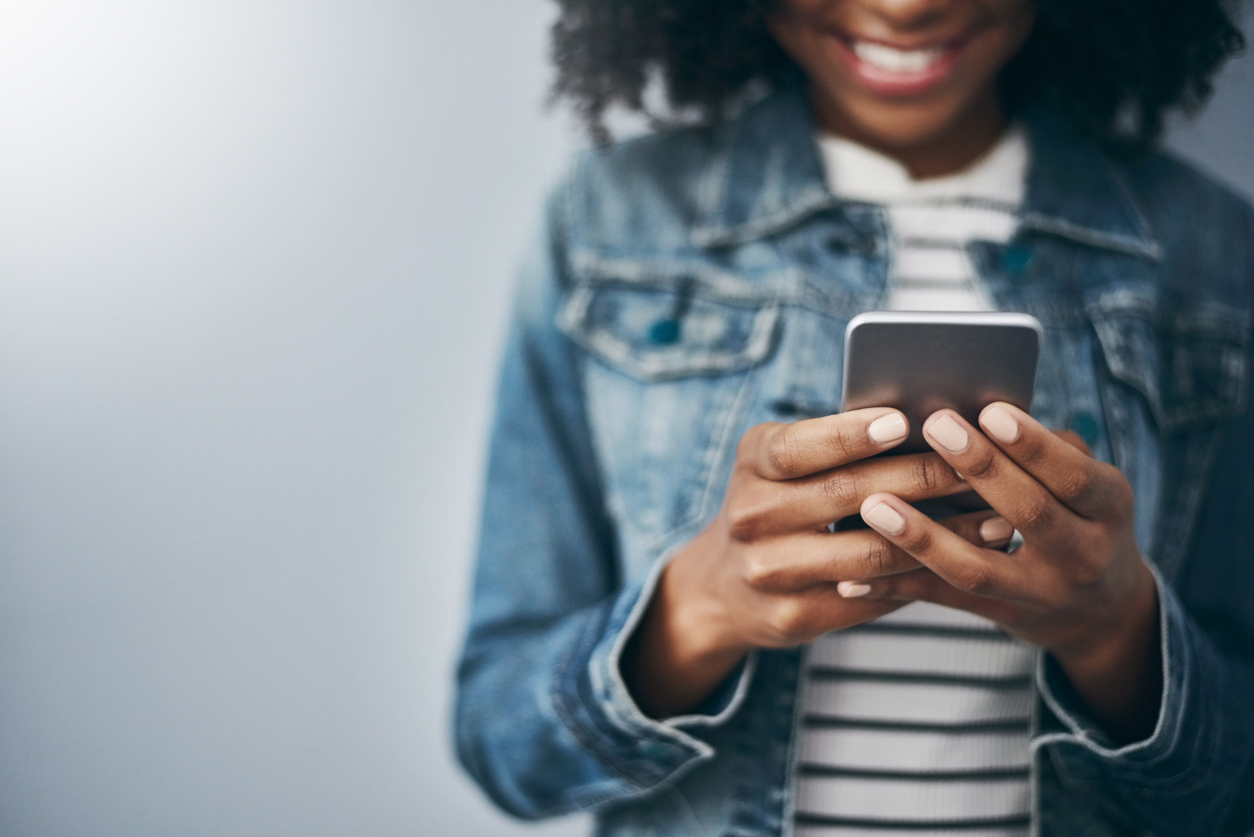 Young woman playing rewarded ads in her phone